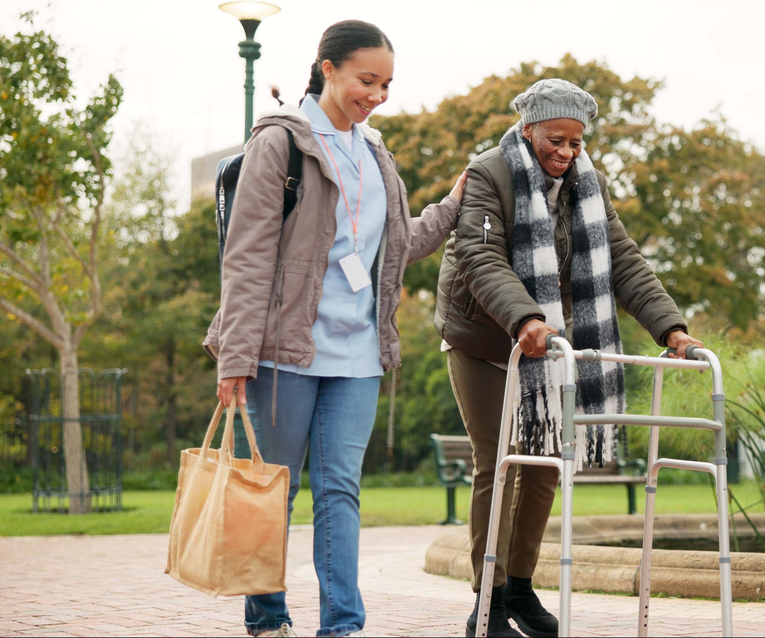 Caregiver assisting an elderly person with walking